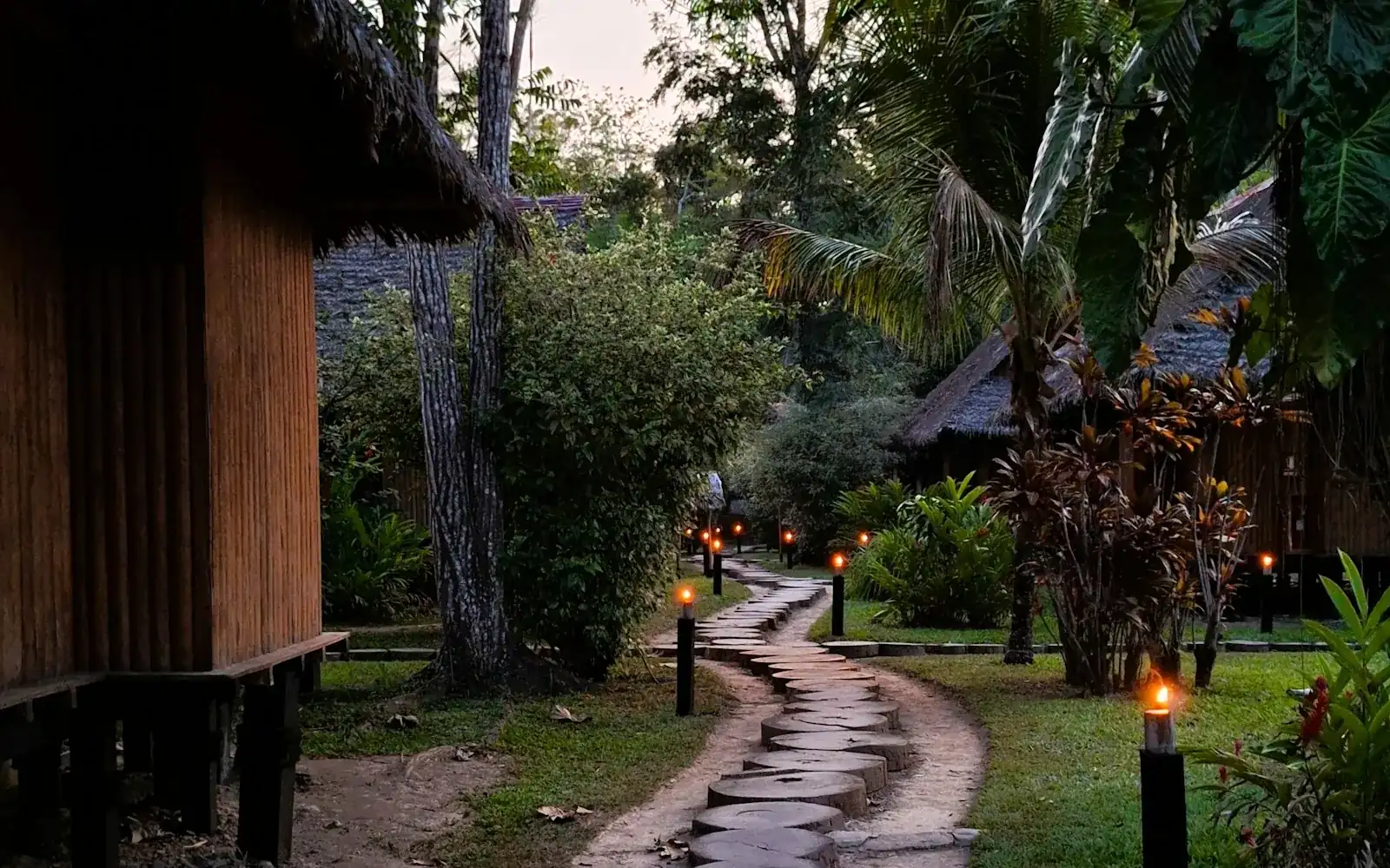 Un chemin de pierre menant à un lodge parmi les arbres